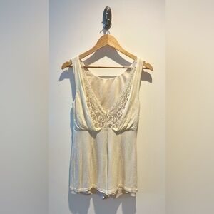 Cream-colored Romper with lace detailing and an open back